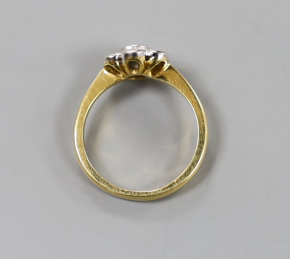 A modern 18ct gold and seven stone collet set diamond flower head cluster ring, size O, gross weight 4.4 grams